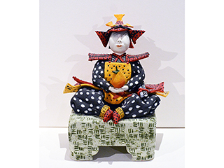 Man w/ squash on stool by Vicky Chock